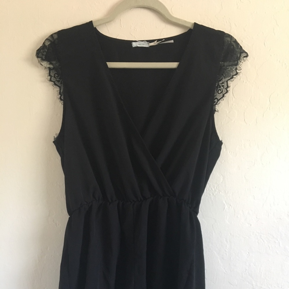 kimchi blue brand black romper with lace detail.